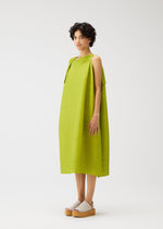 A model wears the PLEATS PLEASE ISSEY MIYAKE BOUNCY BASKET bouncy-basket-dress-yellow-green.
