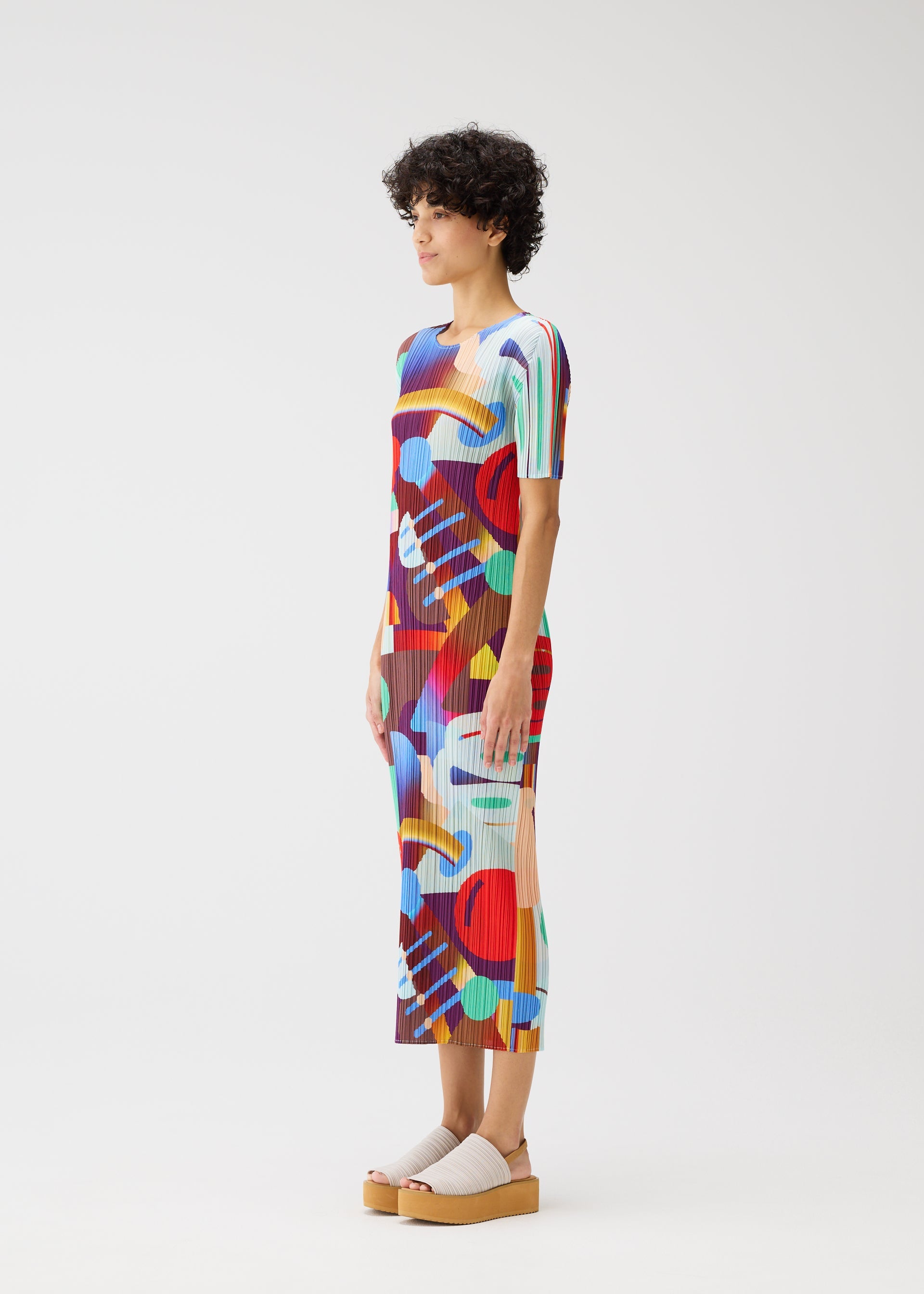 A model wears the Pleats Please Issey Miyake SODA POPS dress.
