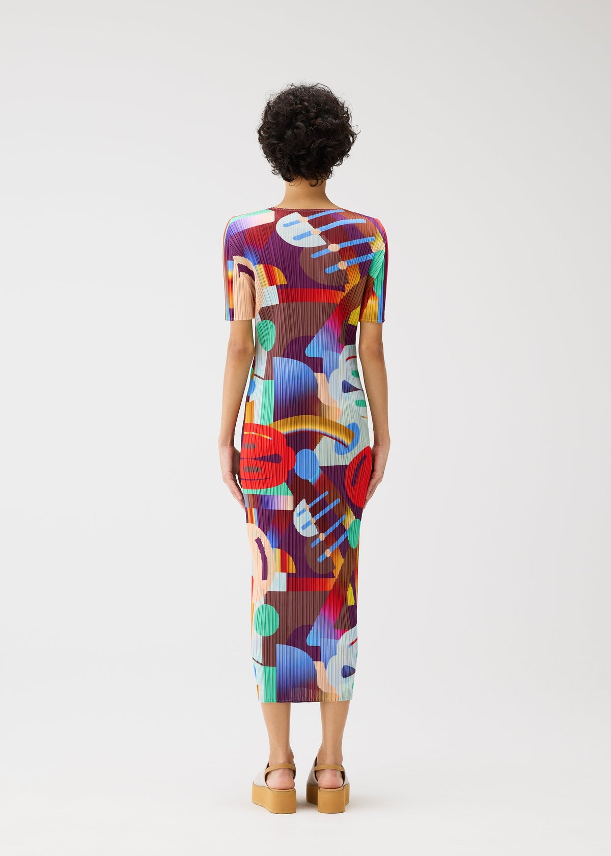 A model wears the Pleats Please Issey Miyake SODA POPS dress.