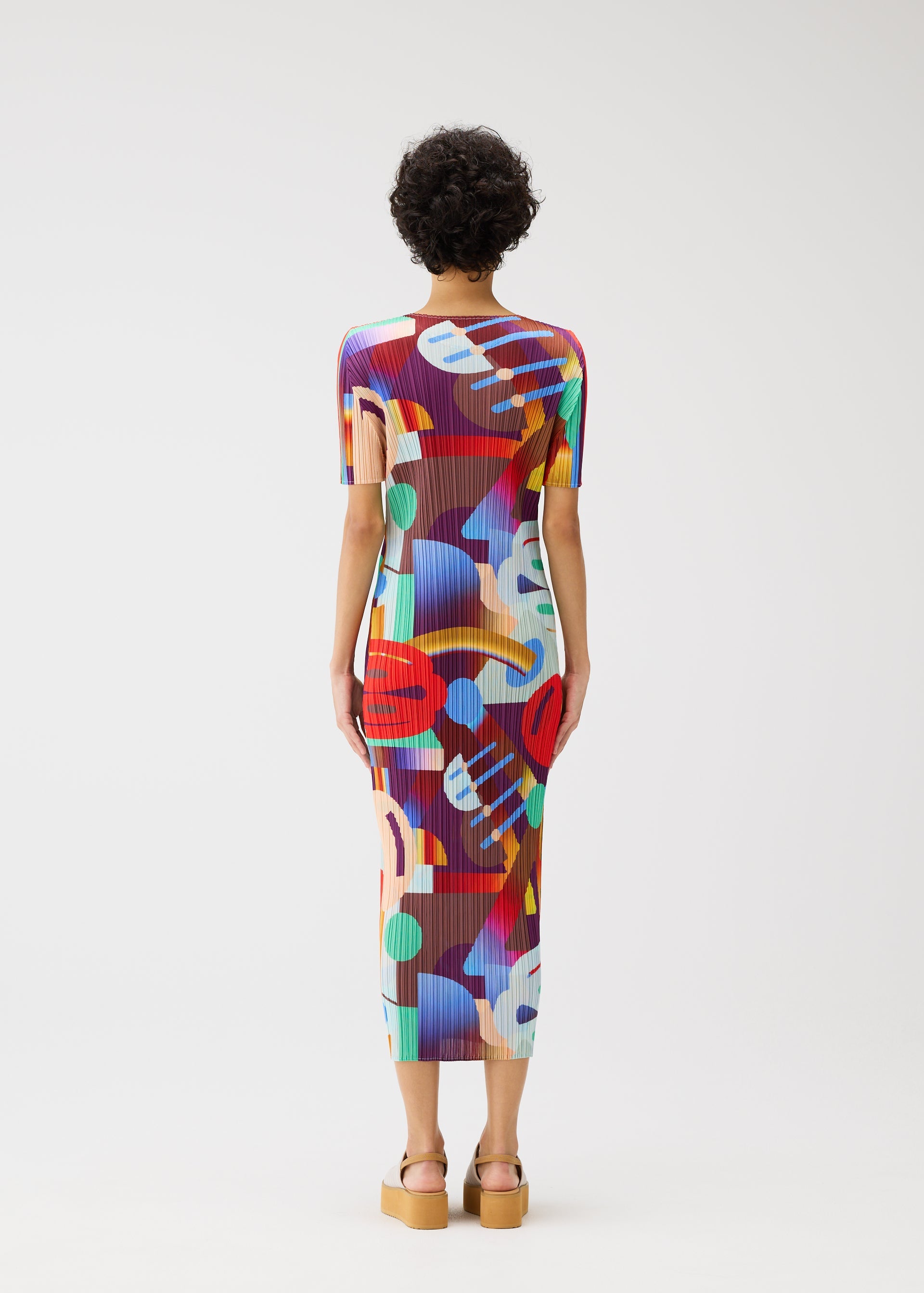 A model wears the Pleats Please Issey Miyake SODA POPS dress.