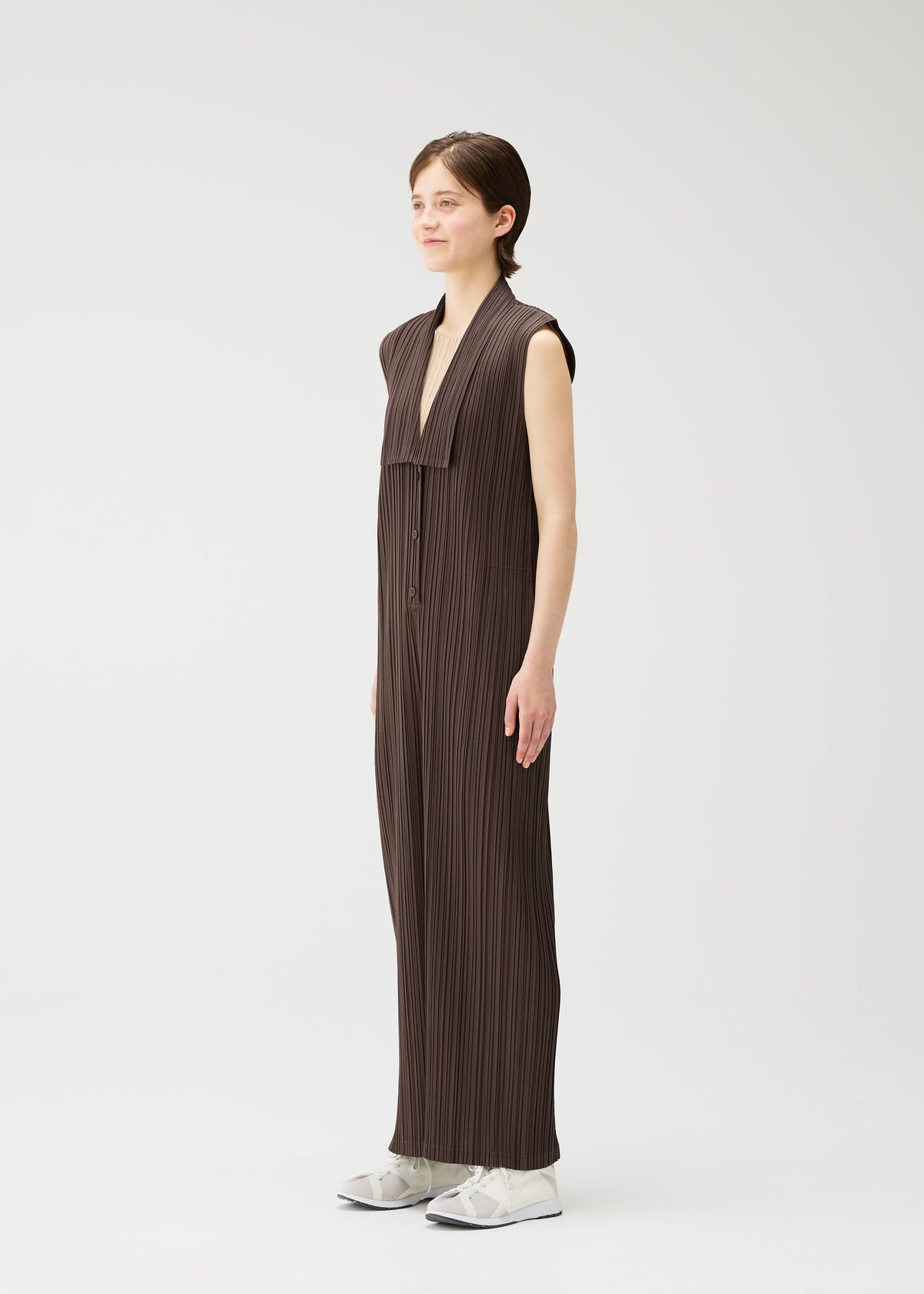 A model wears the Pleats Please Issey Miyake LOOP BOTTOMS jumpsuit.