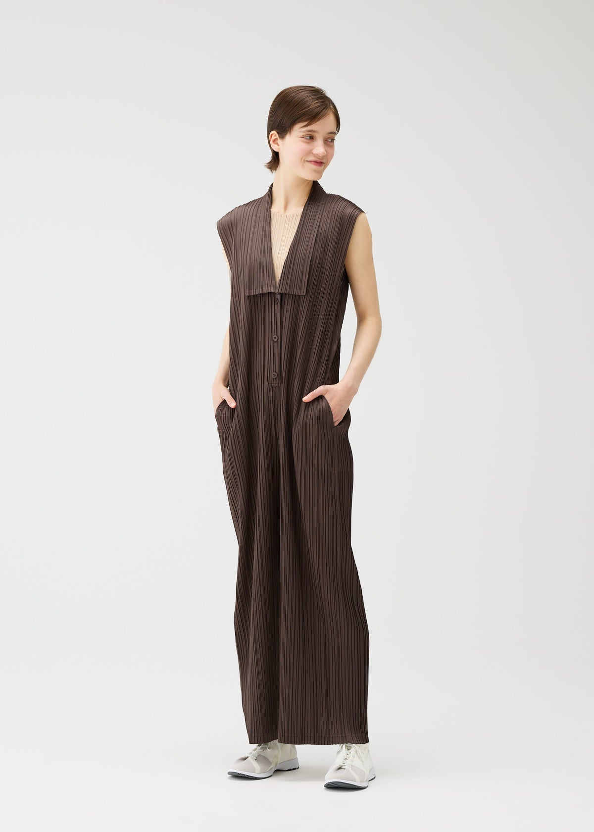 A model wears the Pleats Please Issey Miyake LOOP BOTTOMS jumpsuit.