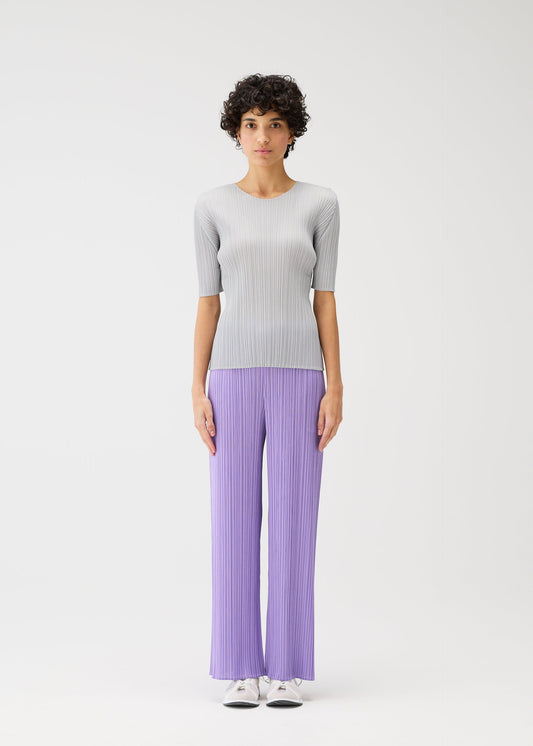 A model wears the Pleats Please Issey Miyake MONTHLY COLORS shirt.