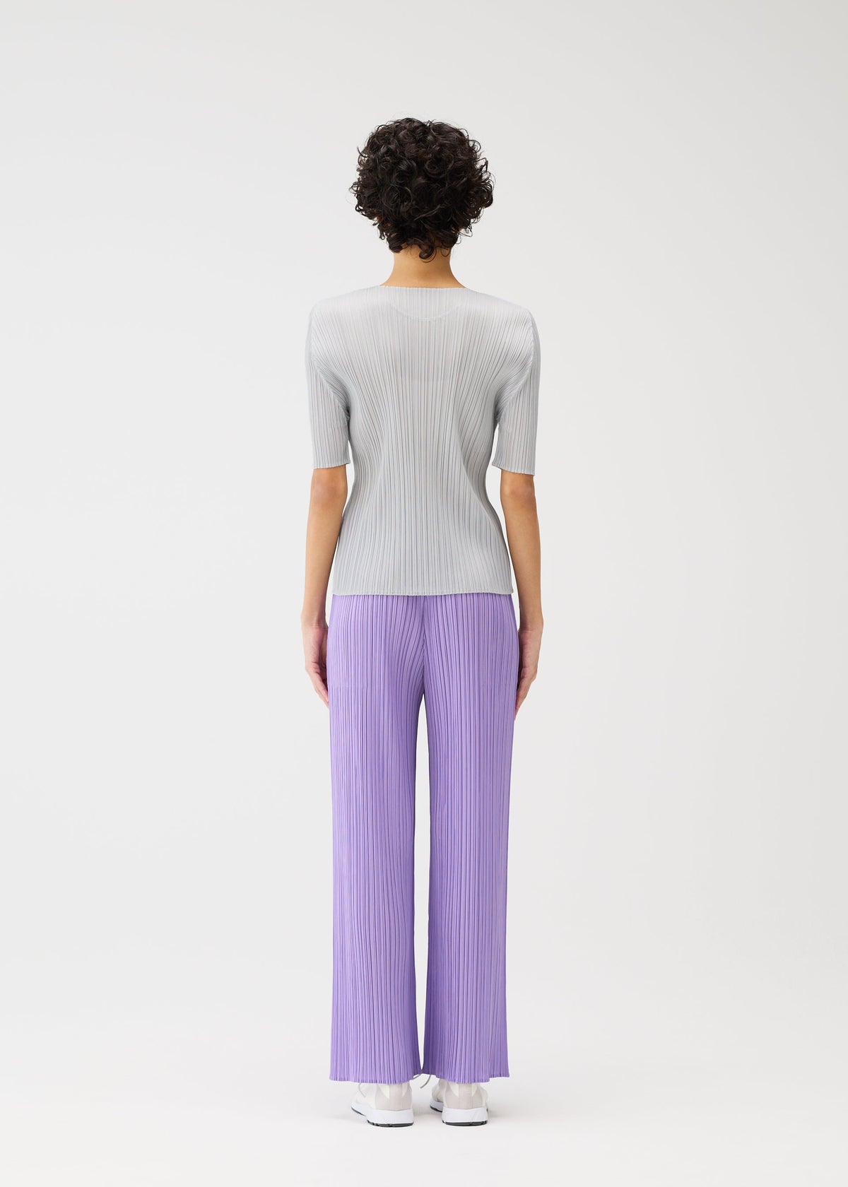 A model wears the Pleats Please Issey Miyake MONTHLY COLORS shirt.