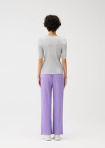 A model wears the Pleats Please Issey Miyake MONTHLY COLORS shirt.