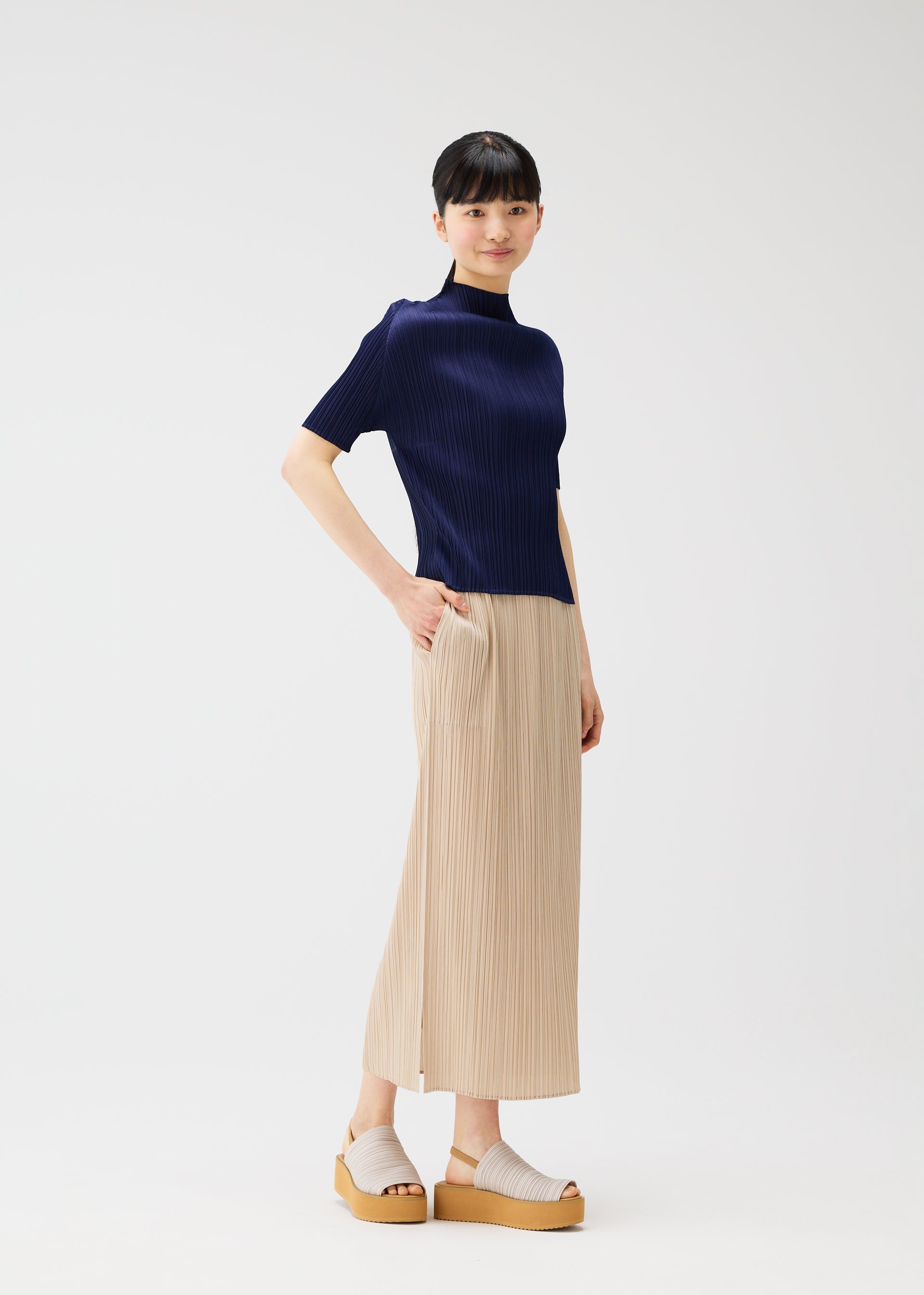 A model wears the Pleats Please Issey Miyake MONTHLY COLORS MAY shirt.