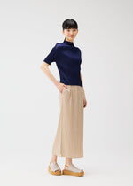 A model wears the Pleats Please Issey Miyake MONTHLY COLORS MAY shirt.