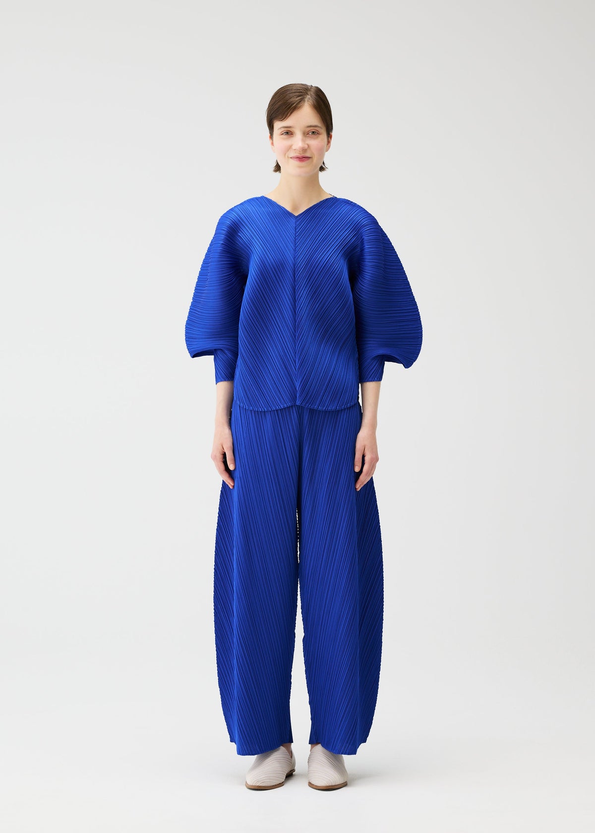 A model wears the PLEATS PLEASE ISSEY MIYAKE COAST pp66jk46143os.
