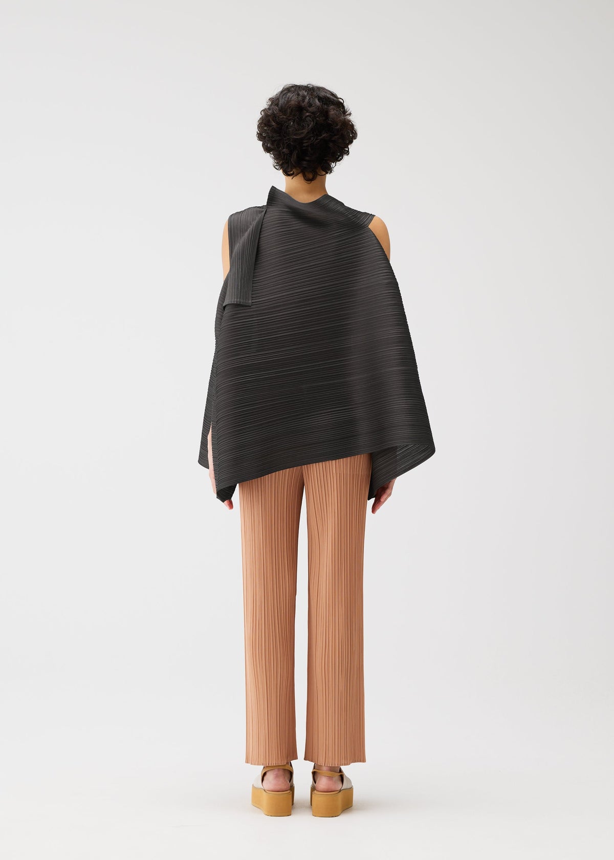 A model wears the PLEATS PLEASE ISSEY MIYAKE BOUNCY BASKET bouncy-basket-shirt-yellow-green.