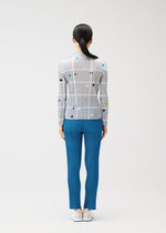 A model wears the PLEATS PLEASE ISSEY MIYAKE CROSSING DOTS prêt à porter.