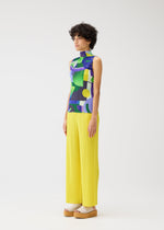 A model wears the Pleats Please Issey Miyake SODA POPS shirt.