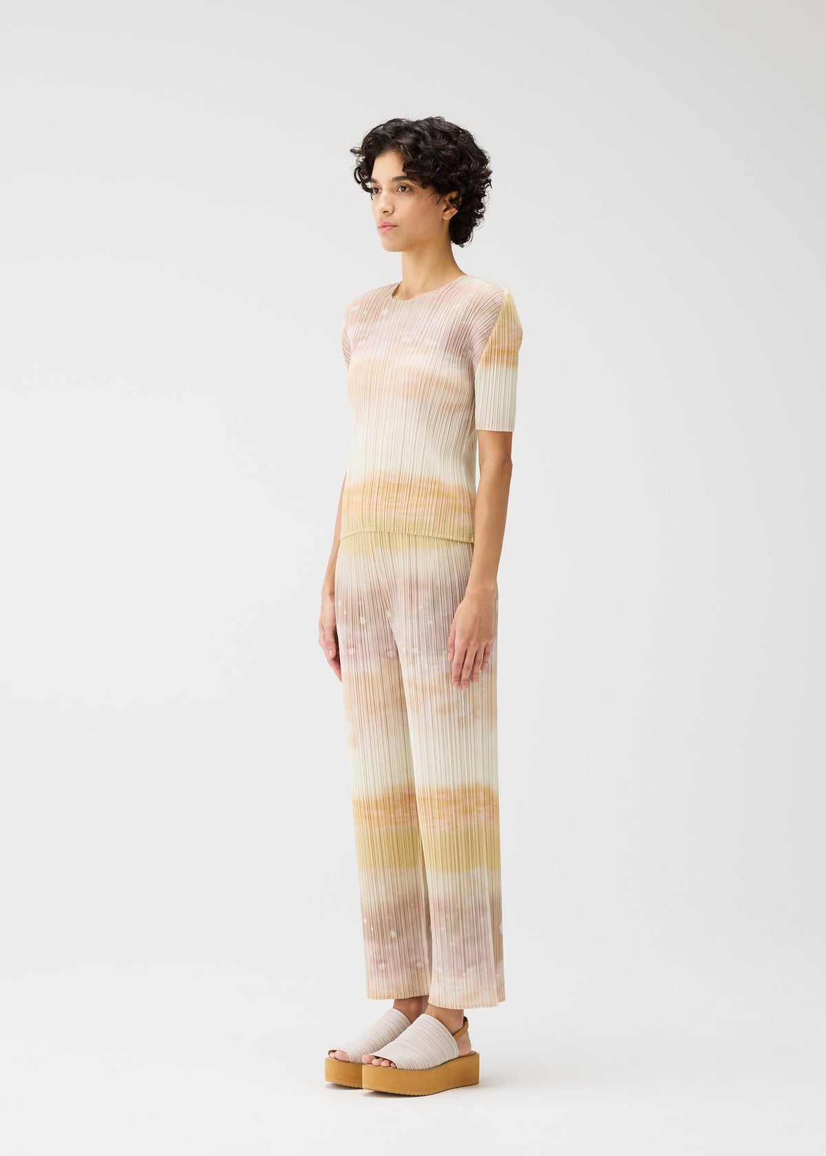 A model wears the Pleats Please Issey Miyake SEA BUBBLE shirt.