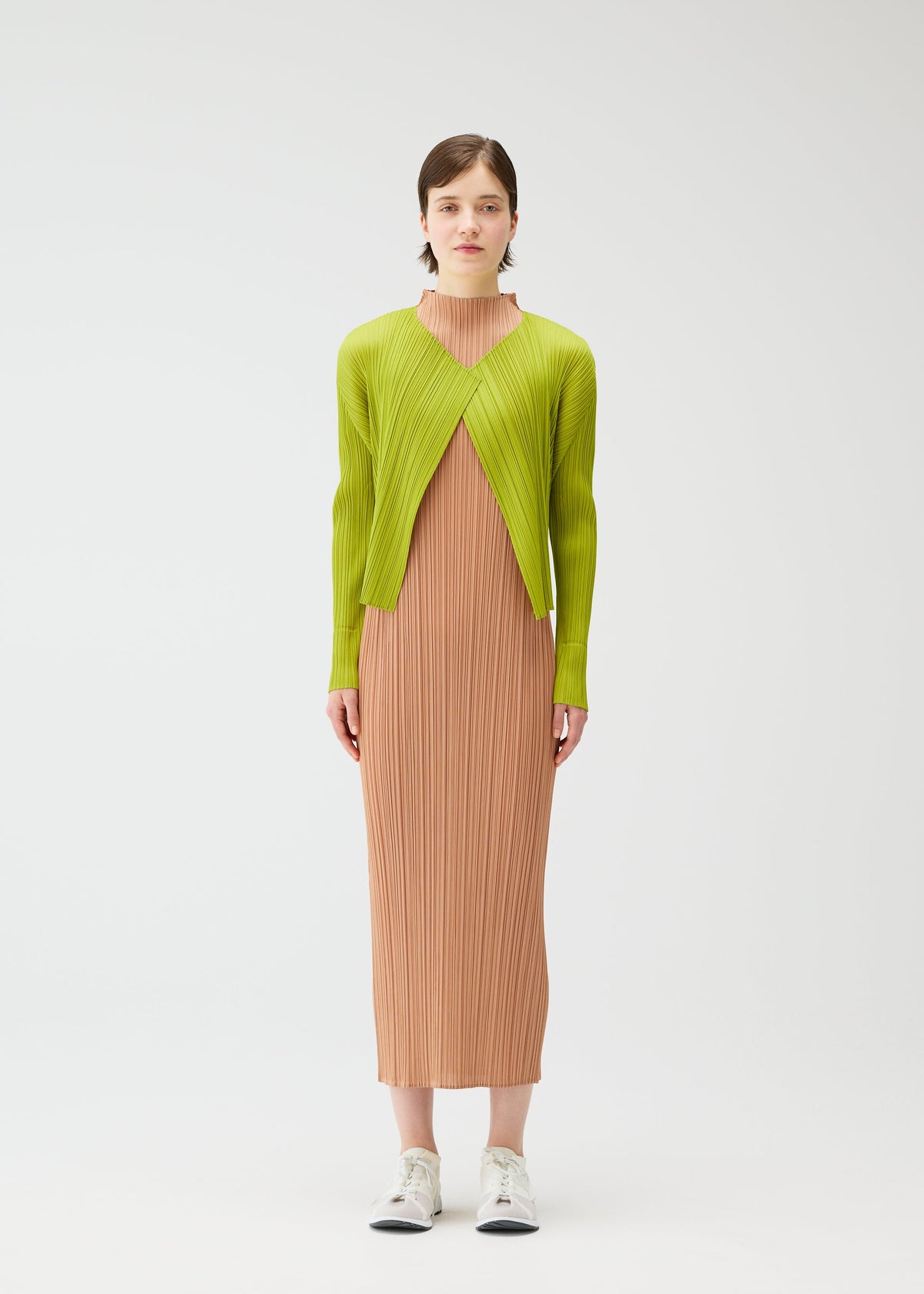 A model wears the PLEATS PLEASE ISSEY MIYAKE MONTHLY COLORS : JUNE monthly-colors-june-cardigan-pink-beige.