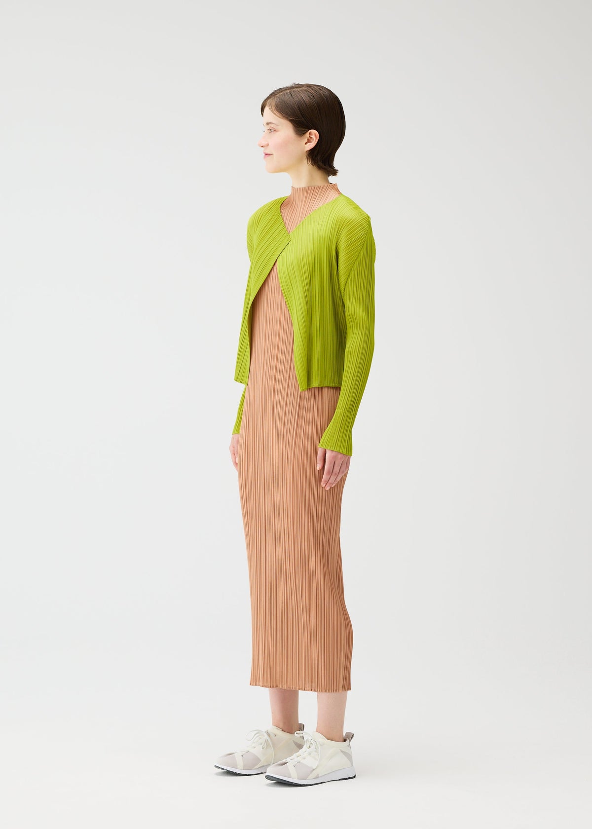A model wears the PLEATS PLEASE ISSEY MIYAKE MONTHLY COLORS : JUNE monthly-colors-june-cardigan-blue-green-1.