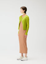 A model wears the PLEATS PLEASE ISSEY MIYAKE MONTHLY COLORS : JUNE monthly-colors-june-cardigan-bright-pink-1.