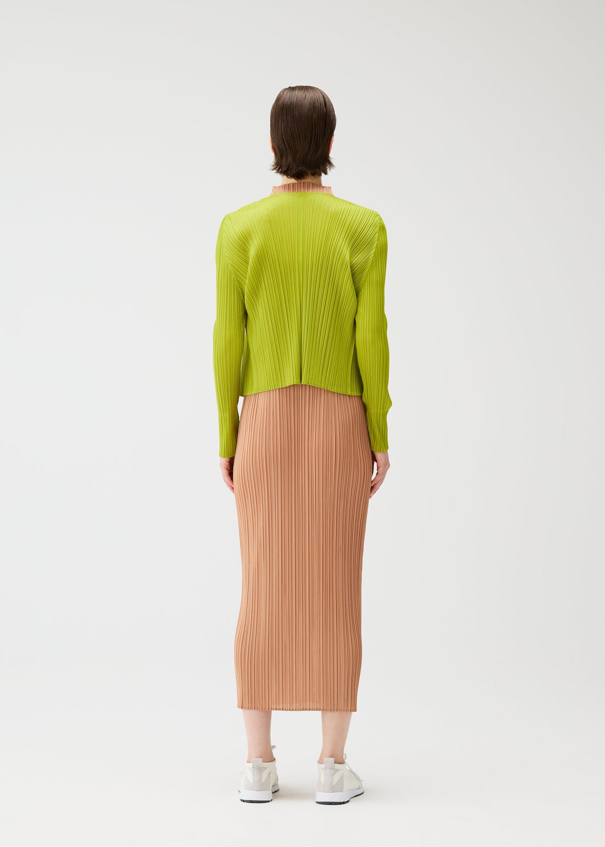 A model wears the PLEATS PLEASE ISSEY MIYAKE MONTHLY COLORS : JUNE monthly-colors-june-cardigan-yellow-green.