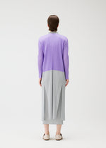 A model wears the Pleats Please Issey Miyake SWING cardigan.
