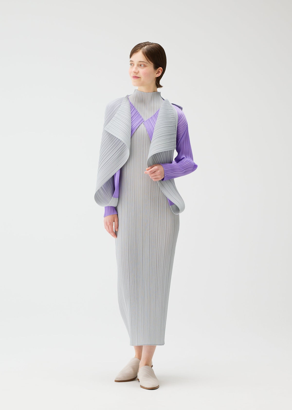 A model wears the Pleats Please Issey Miyake SWING cardigan.