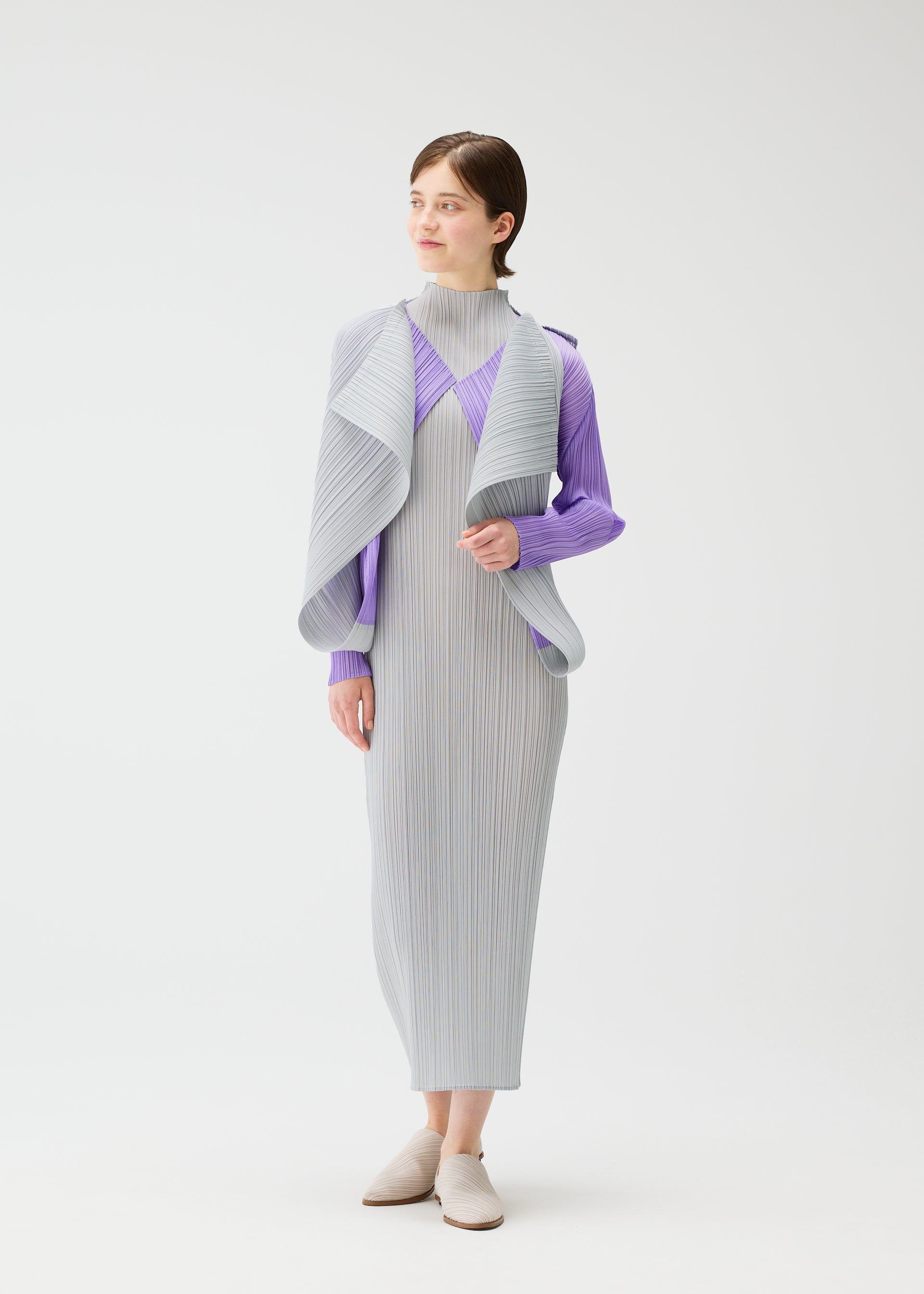 A model wears the Pleats Please Issey Miyake SWING cardigan.