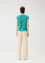 A model wears the Pleats Please Issey Miyake FISHNET KNIT vest.