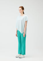 A model wears the Pleats Please Issey Miyake A POC SEA GLASS shirt.