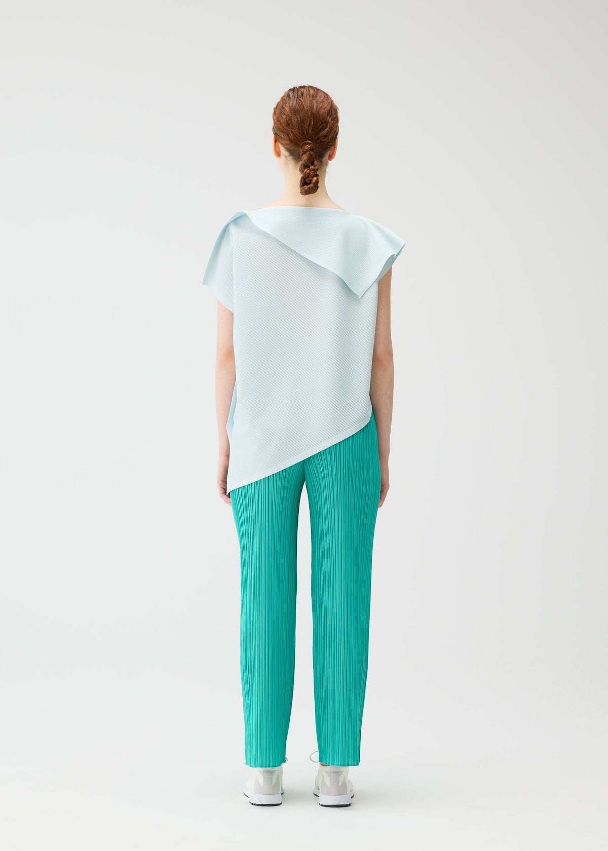 A model wears the Pleats Please Issey Miyake A POC SEA GLASS shirt.