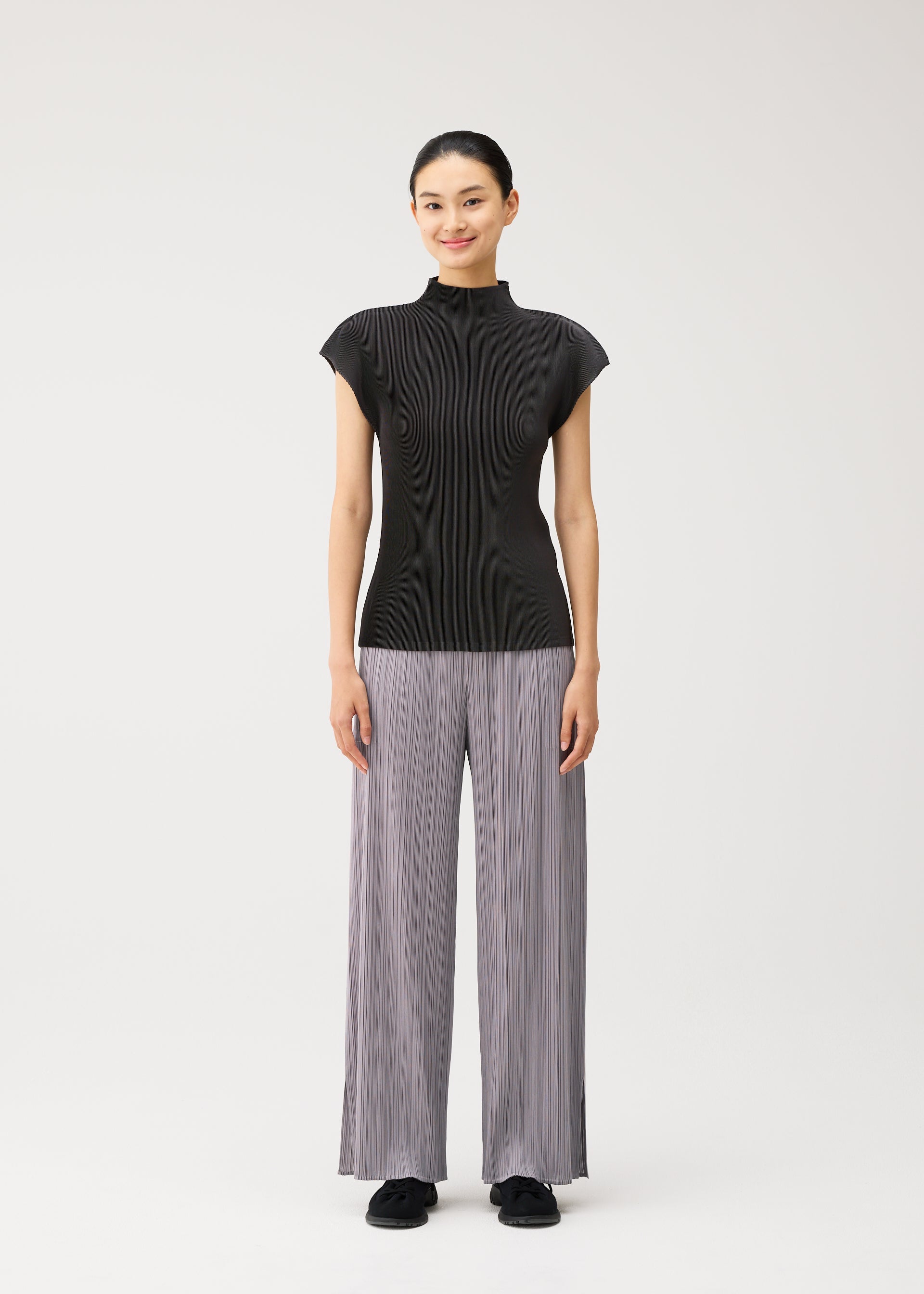 A model wears the PLEATS PLEASE ISSEY MIYAKE MIST AUGUST mist-august-shirt-light-blue.