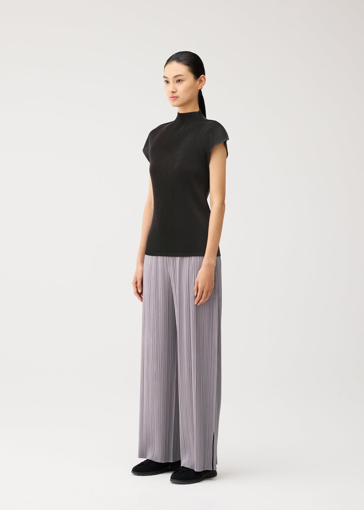 A model wears the PLEATS PLEASE ISSEY MIYAKE MIST AUGUST mist-august-shirt-charcoal.