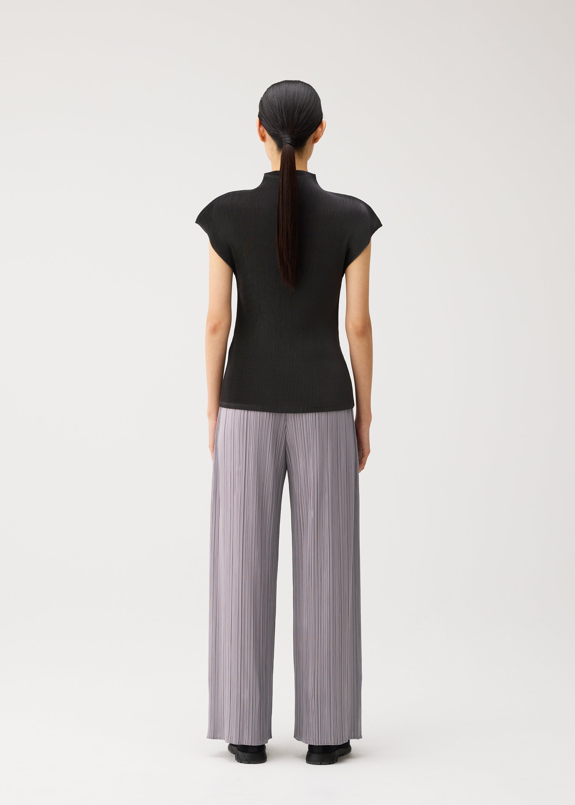 A model wears the PLEATS PLEASE ISSEY MIYAKE MIST AUGUST mist-august-shirt-light-blue.