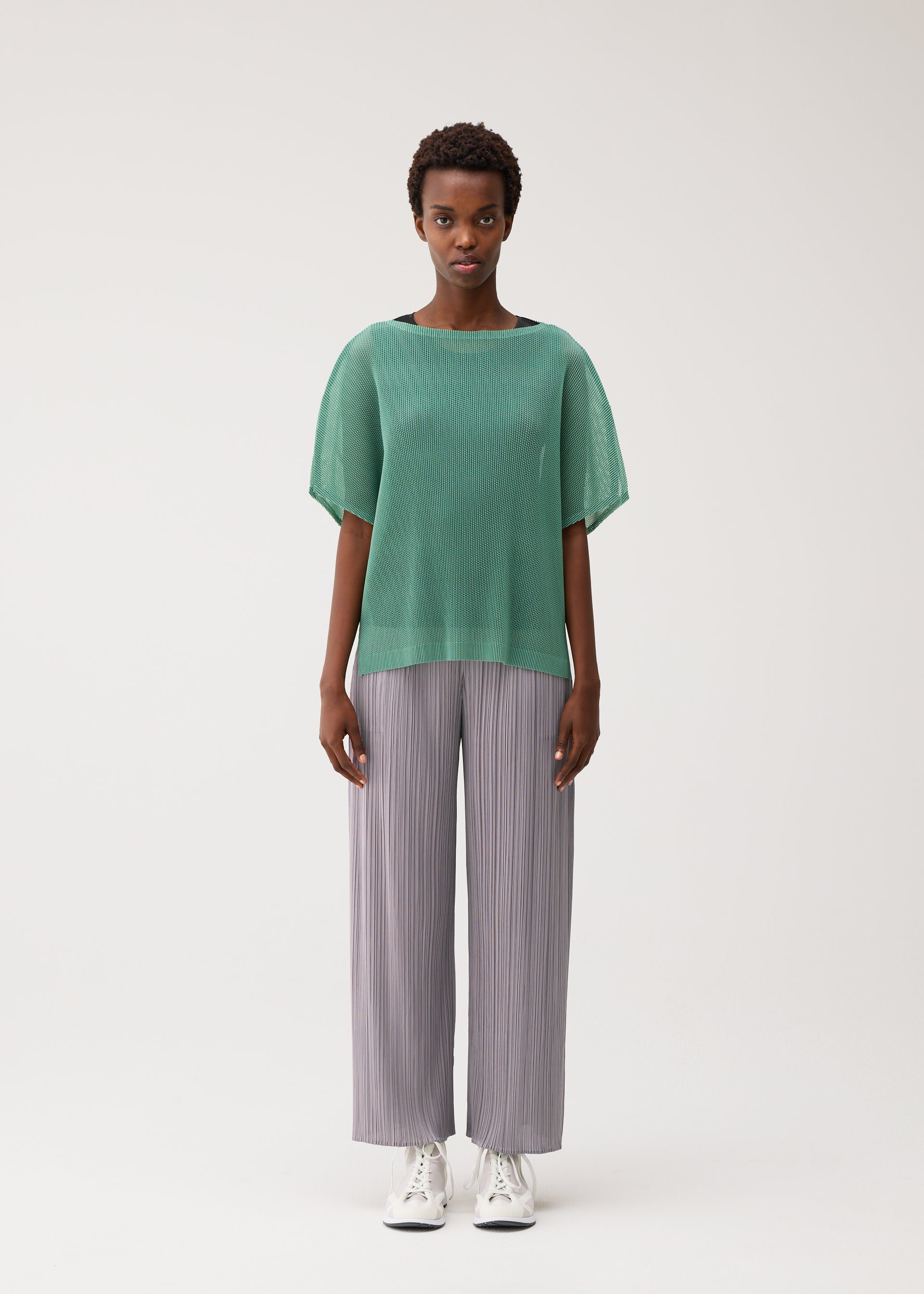 A model wears the PLEATS PLEASE ISSEY MIYAKE TATAMI AUGUST tatami-august-shirt-off-white.