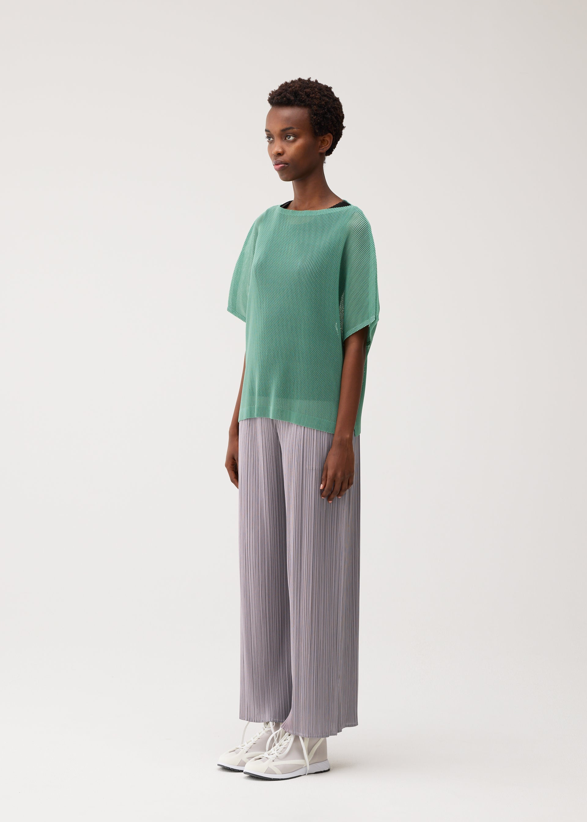 A model wears the PLEATS PLEASE ISSEY MIYAKE TATAMI AUGUST tatami-august-shirt-off-white.