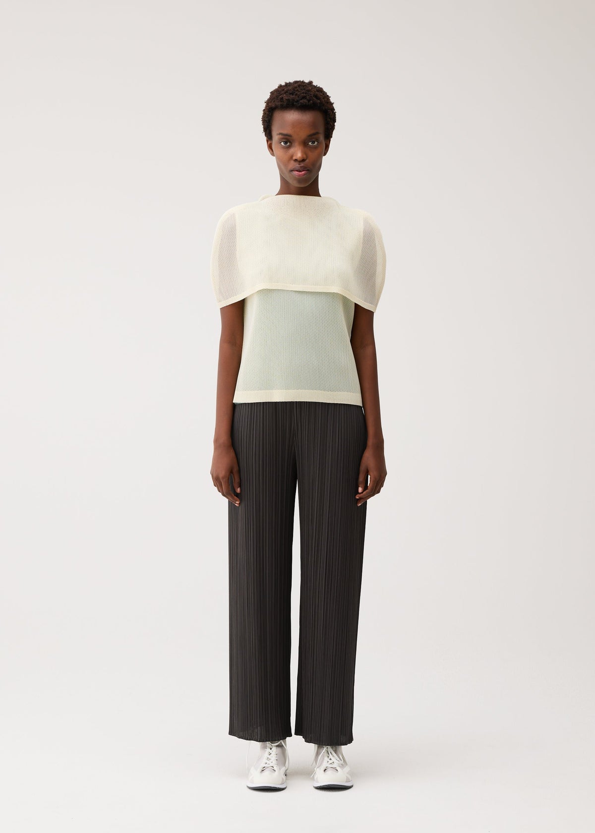 A model wears the PLEATS PLEASE ISSEY MIYAKE TATAMI AUGUST tatami-august-shirt-greyish-green-1.