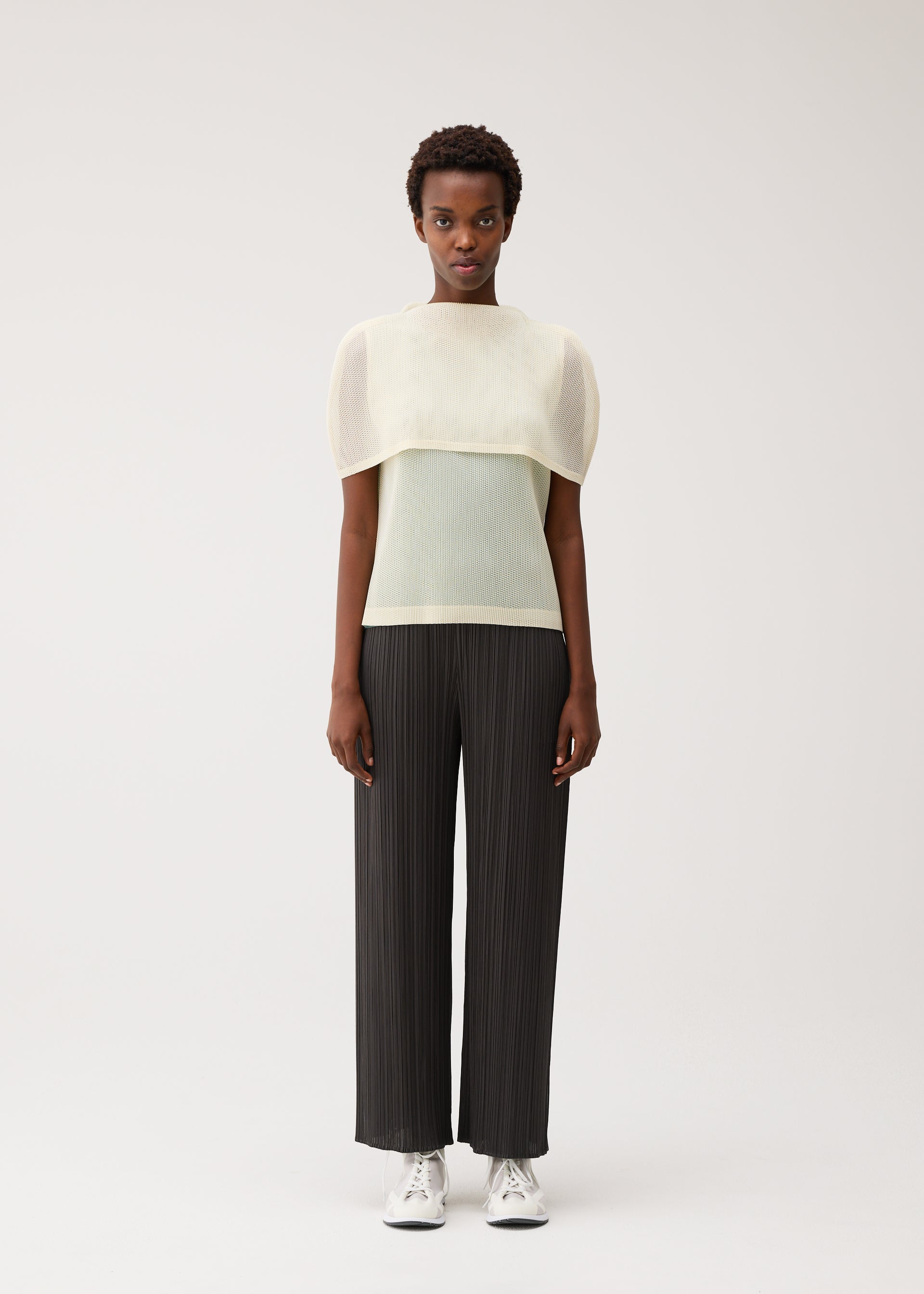 A model wears the PLEATS PLEASE ISSEY MIYAKE TATAMI AUGUST tatami-august-shirt-greyish-green-1.