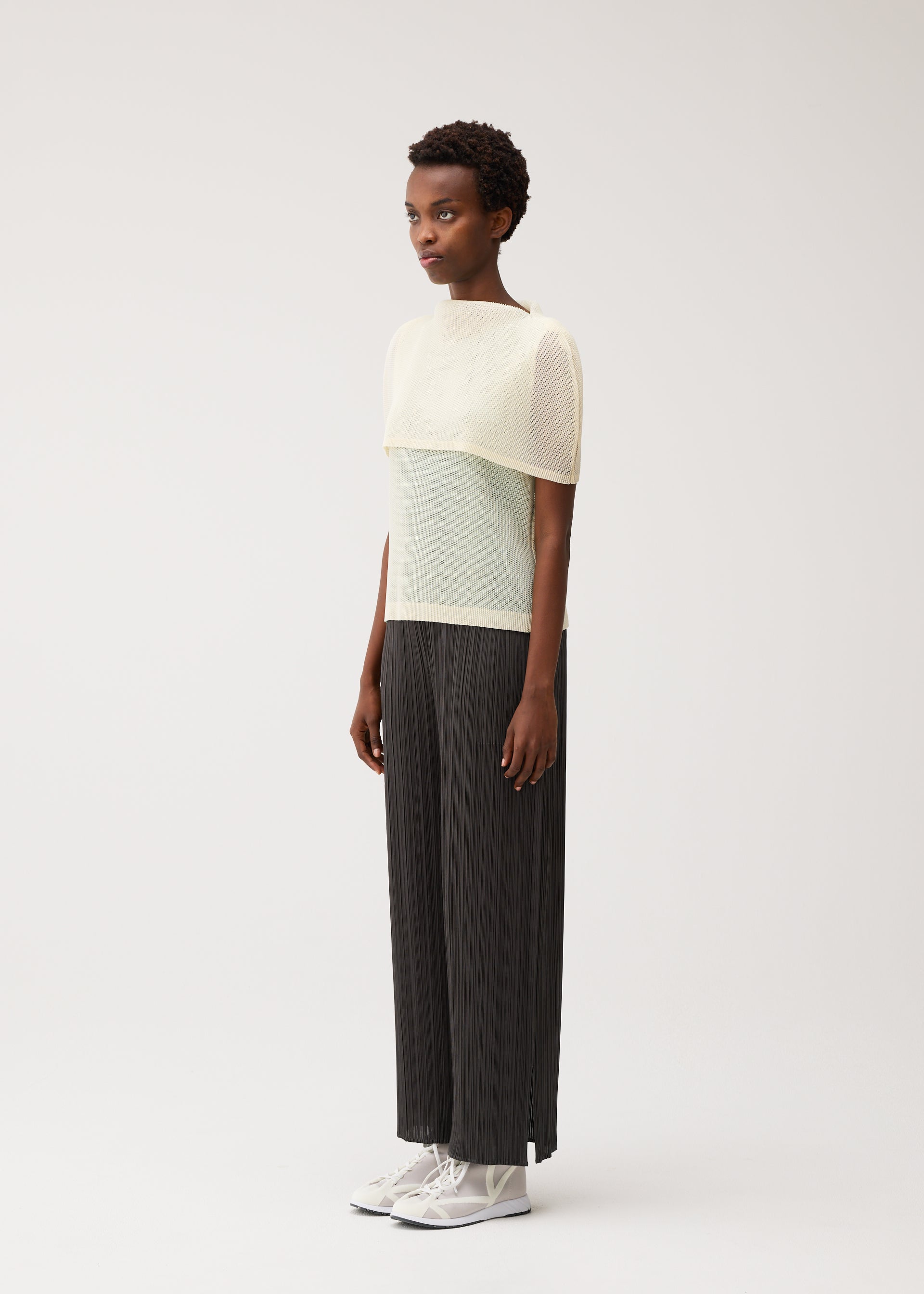 A model wears the PLEATS PLEASE ISSEY MIYAKE TATAMI AUGUST tatami-august-shirt-off-white-1.