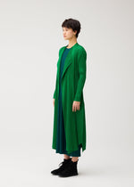 A model wears the PLEATS PLEASE ISSEY MIYAKE MONTHLY COLORS : OCTOBER coat.
