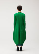 A model wears the PLEATS PLEASE ISSEY MIYAKE MONTHLY COLORS : OCTOBER coat.