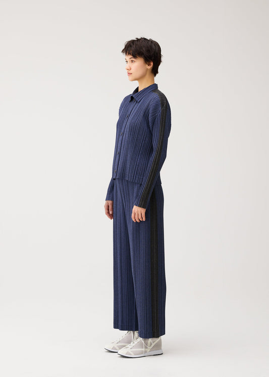 A model wears the PLEATS PLEASE ISSEY MIYAKE COTTON DENIM blouson.