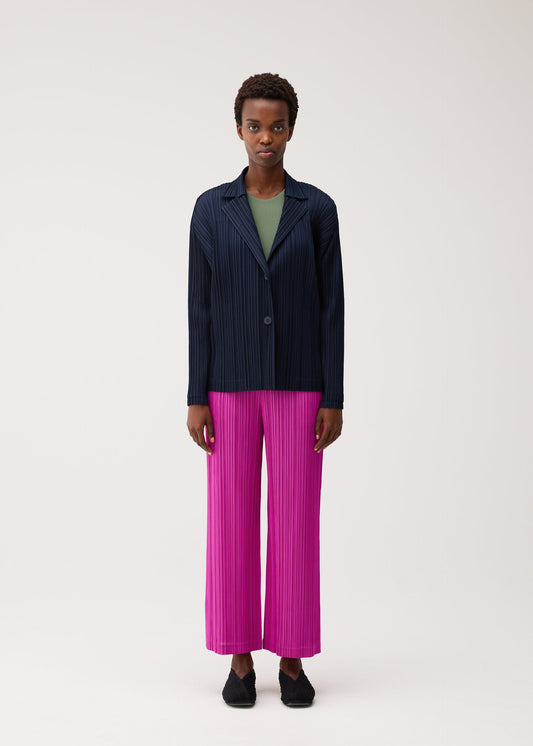 A model wears the PLEATS PLEASE ISSEY MIYAKE PLEATS JACKET jacket.