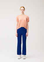 A model wears the PLEATS PLEASE ISSEY MIYAKE MONTHLY COLORS : JULY monthly-colors-july-pants-7.