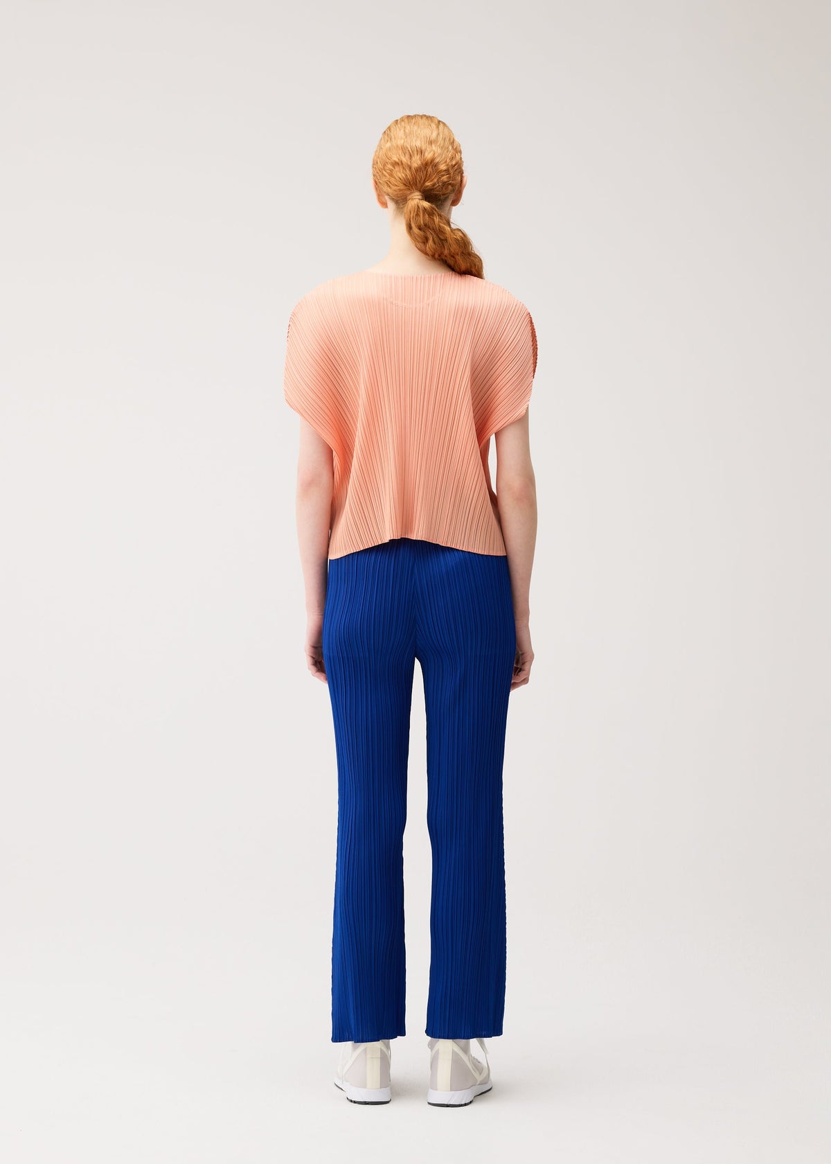 A model wears the PLEATS PLEASE ISSEY MIYAKE MONTHLY COLORS : JULY monthly-colors-july-pants-7.