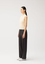 A model wears the PLEATS PLEASE ISSEY MIYAKE MONTHLY COLORS : AUGUST monthly-colors-august-trousers-charcoal-1.