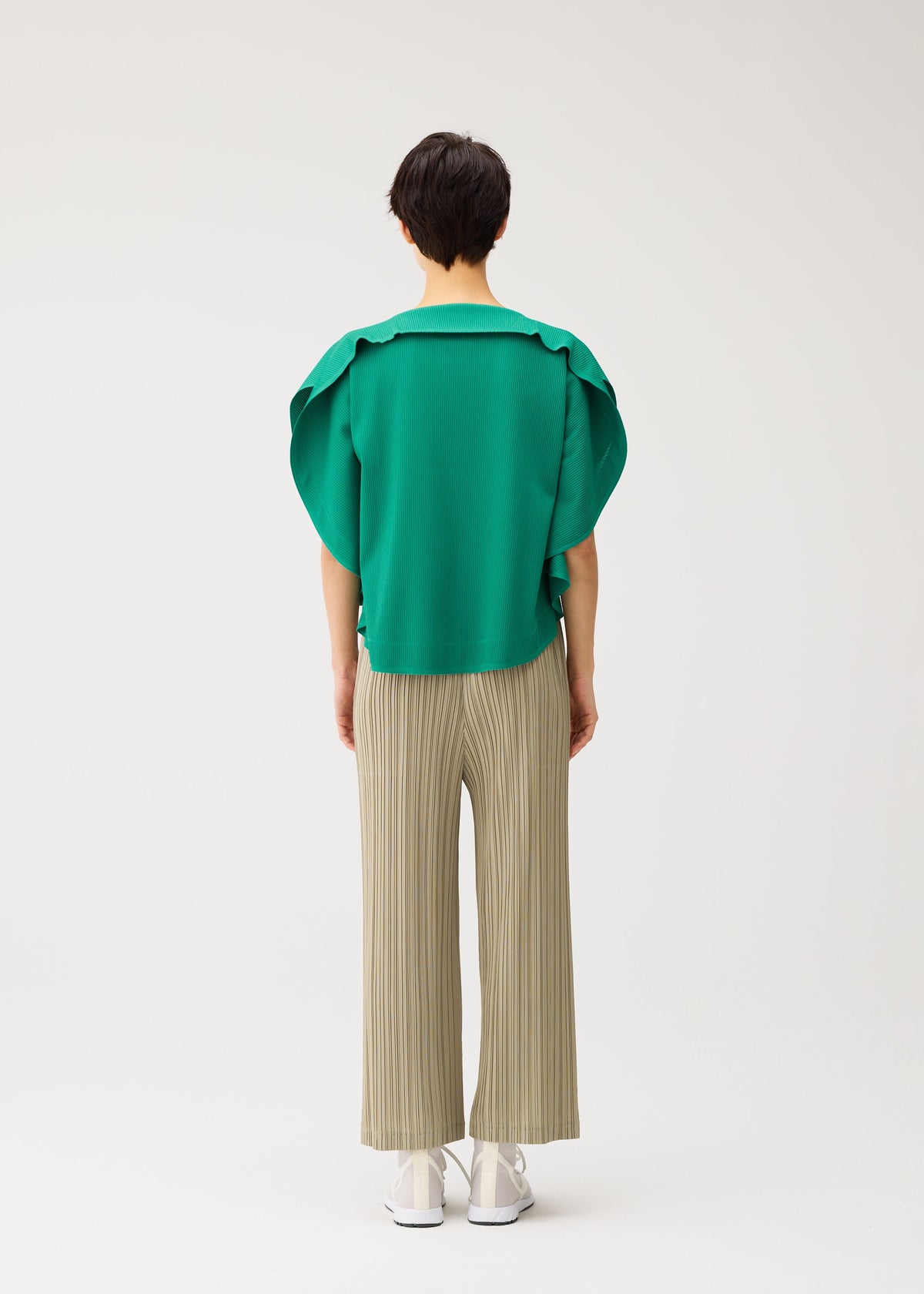 A model wears the PLEATS PLEASE ISSEY MIYAKE THICKER BOTTOMS 1 thicker-bottoms-1-pants-1.
