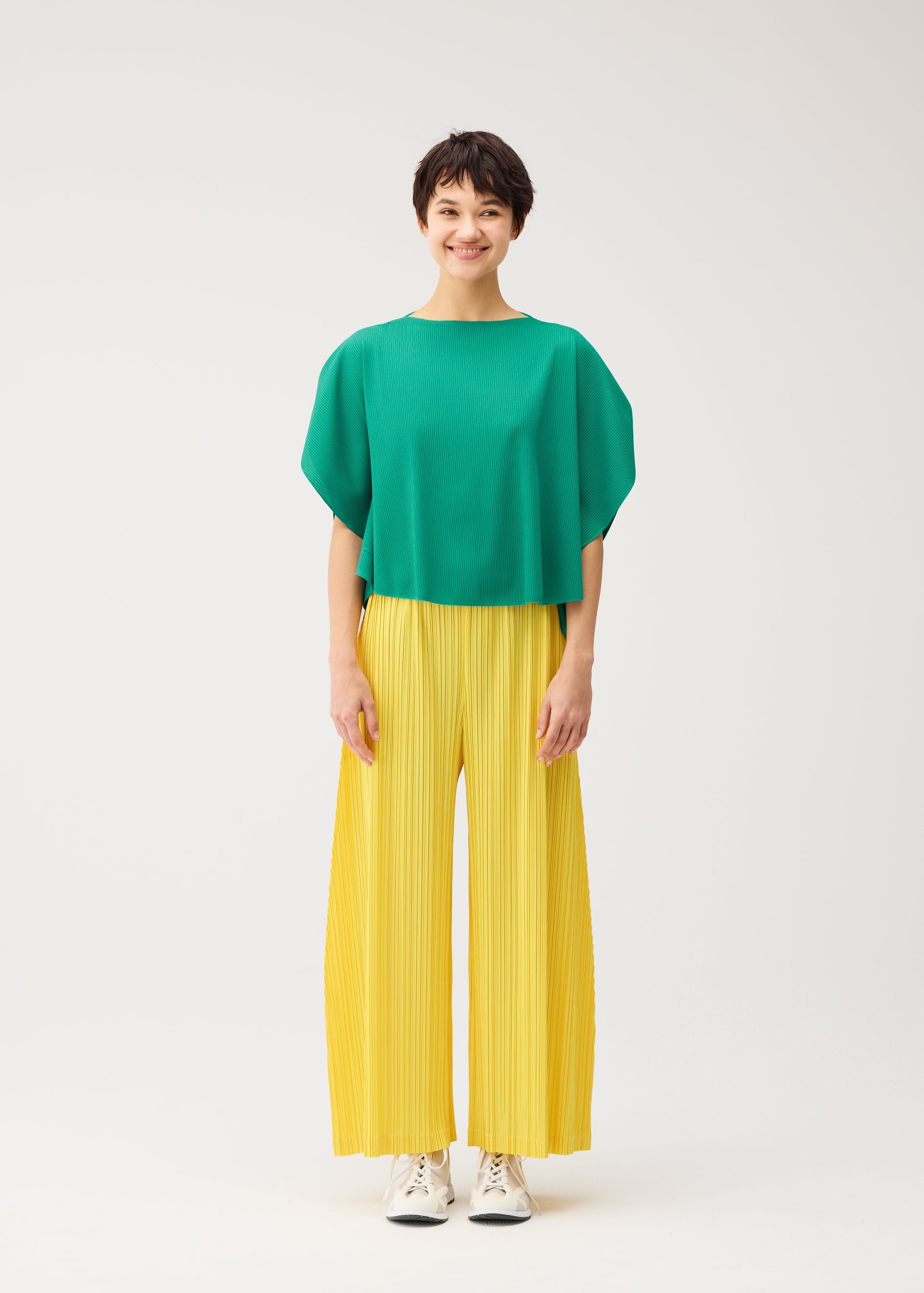 A model wears the PLEATS PLEASE ISSEY MIYAKE THICKER BOTTOMS 1 thicker-bottoms-1-trousers-black-4-fw26.