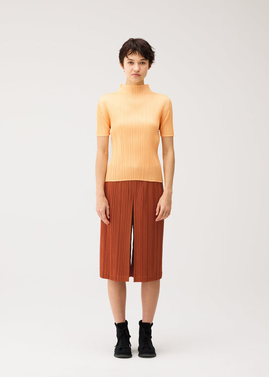 A model wears the PLEATS PLEASE ISSEY MIYAKE THICKER BOTTOMS 2 trousers.
