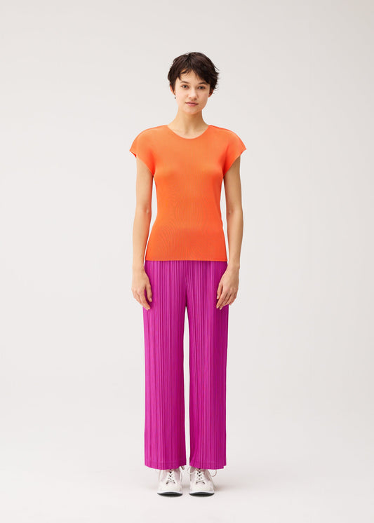 A model wears the PLEATS PLEASE ISSEY MIYAKE THICKER BOTTOMS 2 trousers.