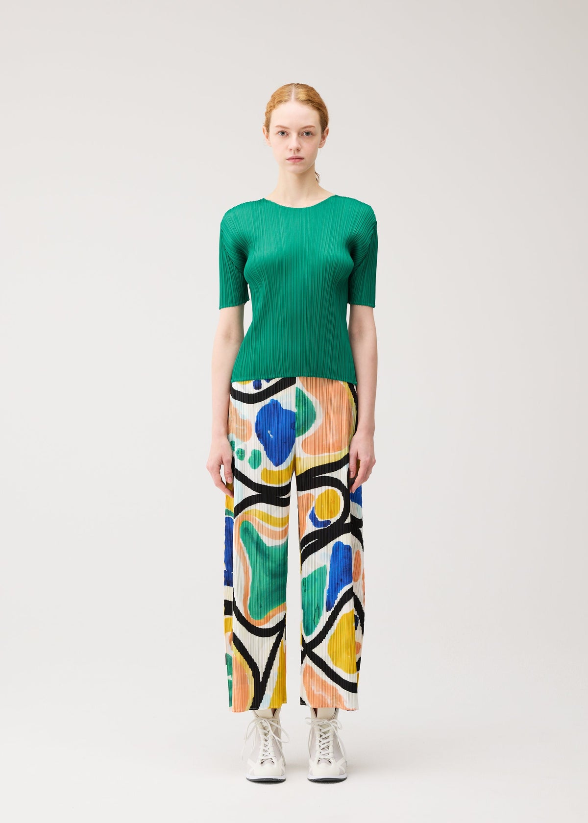 A model wears the PLEATS PLEASE ISSEY MIYAKE ROLL roll-trousers-multi-1.