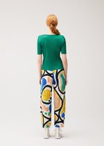 A model wears the PLEATS PLEASE ISSEY MIYAKE ROLL roll-trousers-multi-1.