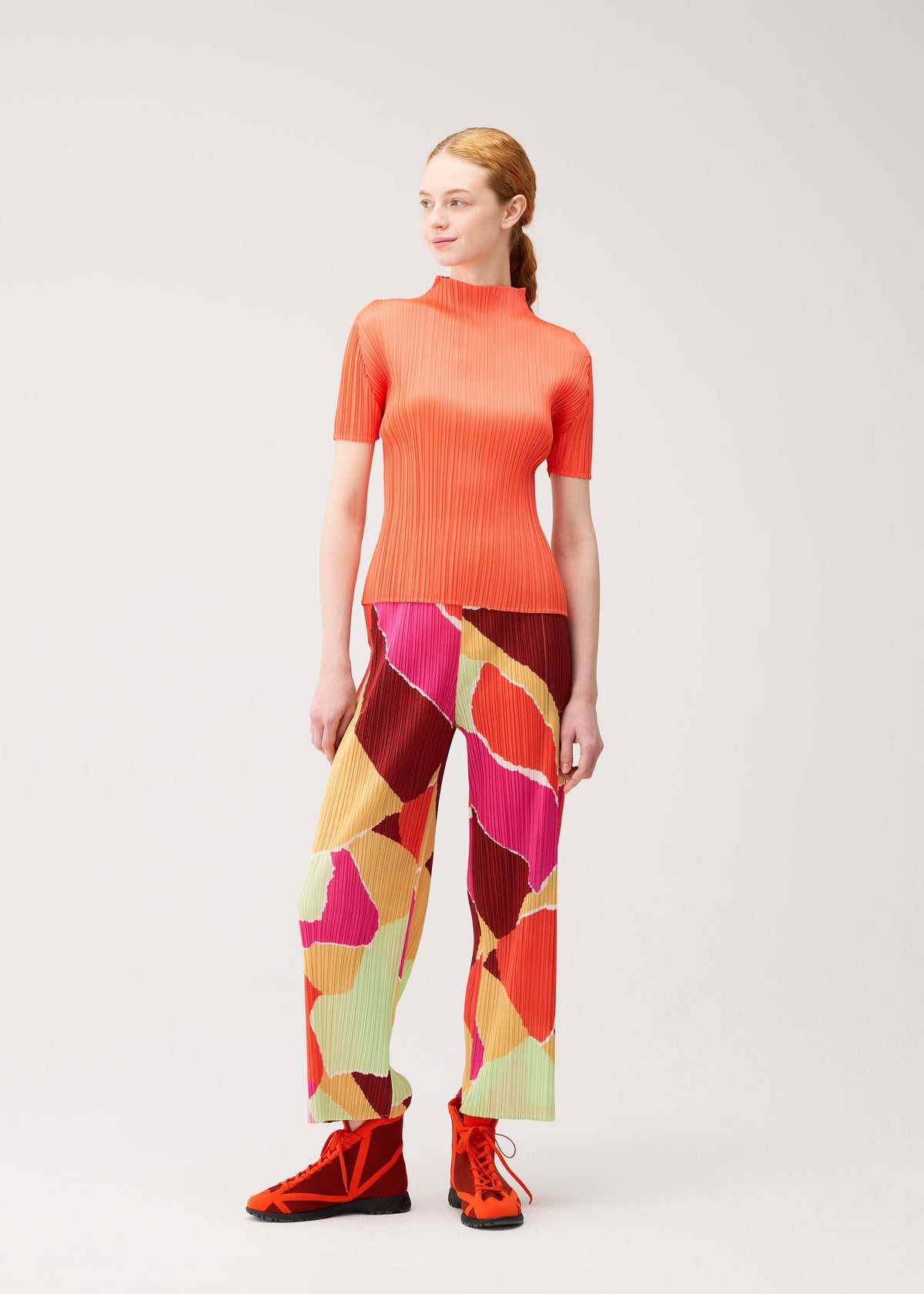 A model wears the PLEATS PLEASE ISSEY MIYAKE SURPRISE! trousers.