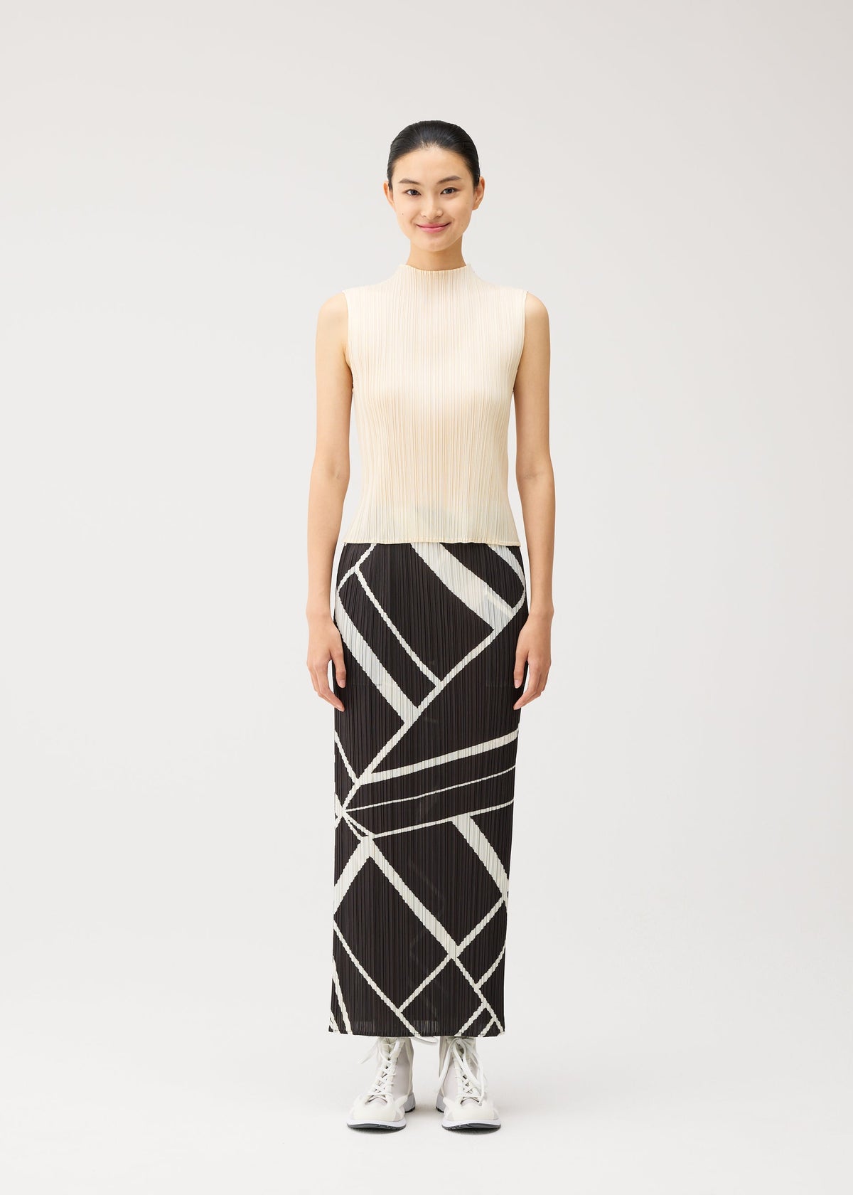 A model wears the PLEATS PLEASE ISSEY MIYAKE FOLD LINE fold-line-skirt-off-white.