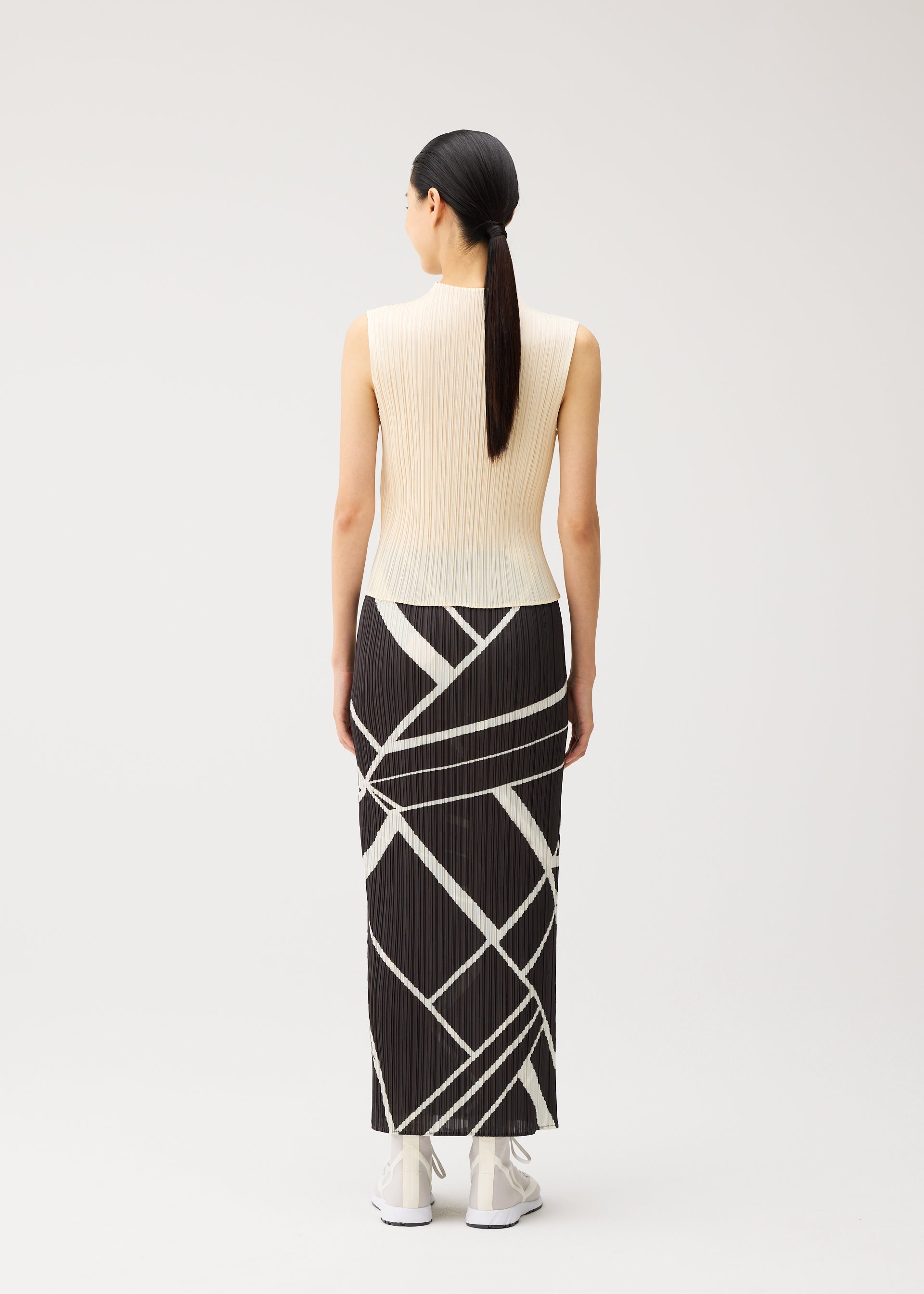 A model wears the PLEATS PLEASE ISSEY MIYAKE FOLD LINE fold-line-skirt-off-white.